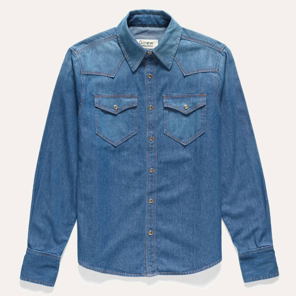 Front view of the Western Snap Shirt in Washed Chambray featuring dual chest pockets, faux tortoise snap buttons, and a classic Western silhouette in faded blue cotton chambray.