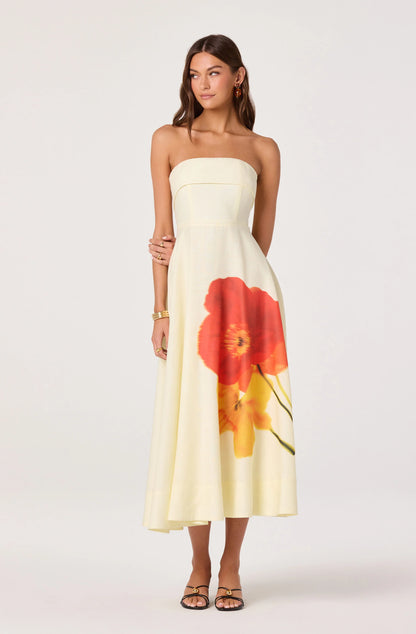 Model wearing the Ximena Floral Strapless Midi Dress with a fitted strapless bodice, A-line skirt, and bold floral print at the front.