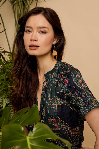 Close-up of model wearing the Zola Top in Patchwork Flower, highlighting the mixed floral print, gathered neckline, and short sleeves