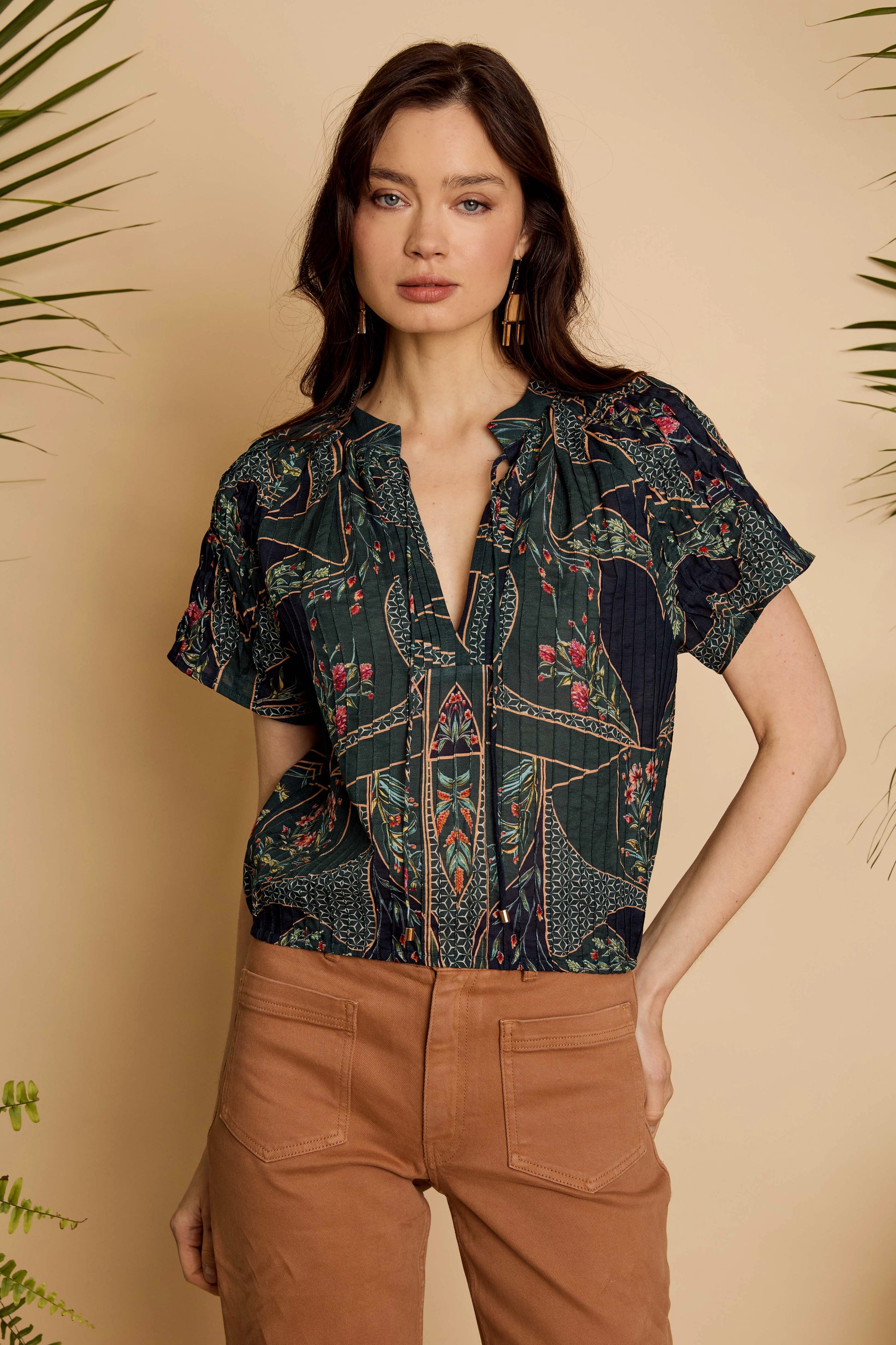 Front detail of the Zola Top in Patchwork Flower showing the split neckline, tie detail, and short sleeves