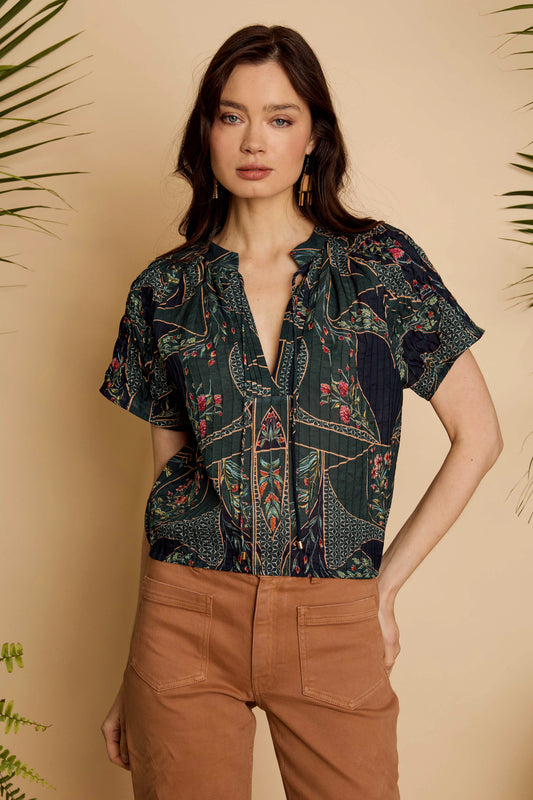 Front detail of the Zola Top in Patchwork Flower showing the split neckline, tie detail, and short sleeves