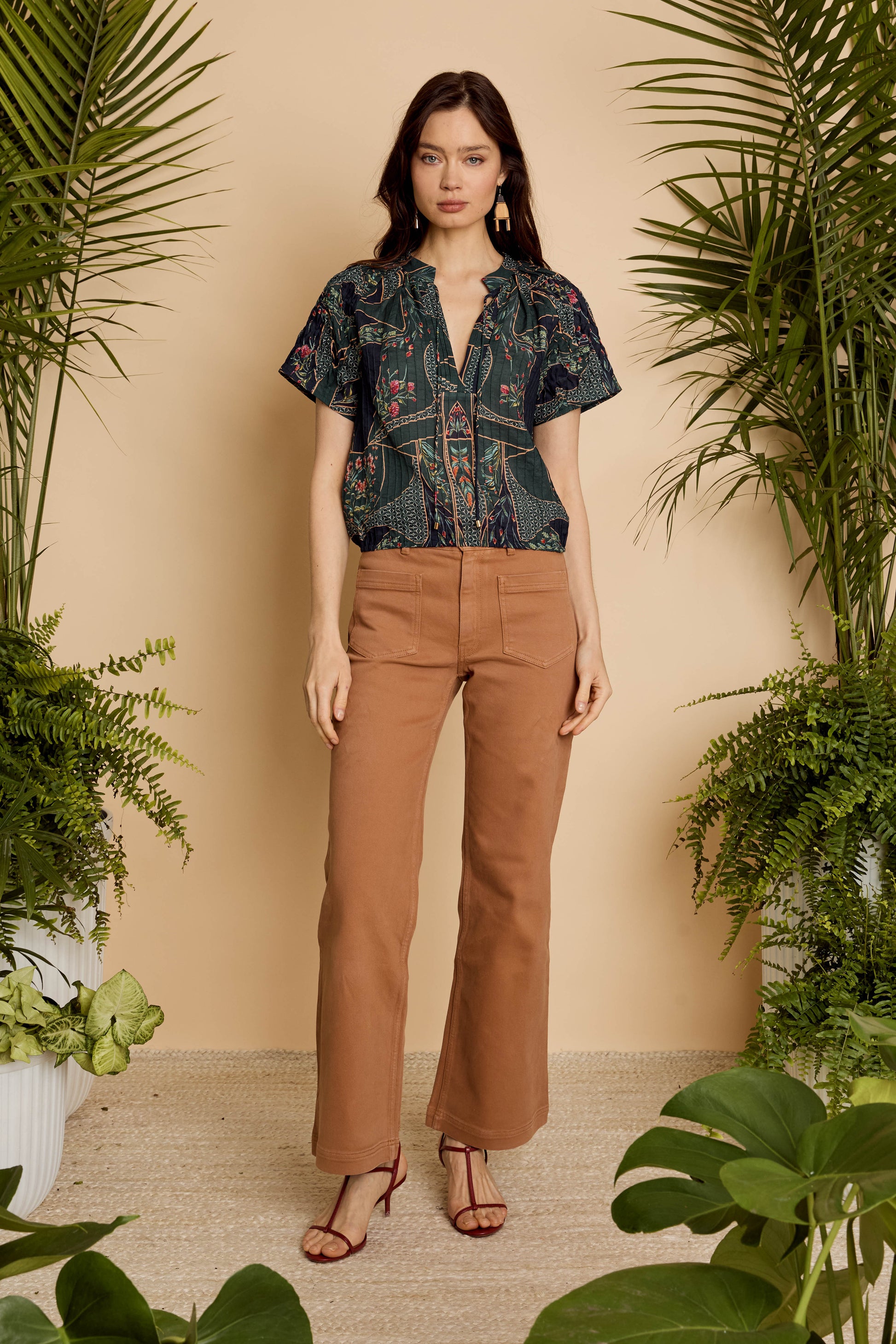 Model wearing the Zola Top in Patchwork Flower with brown pants, front full-length view