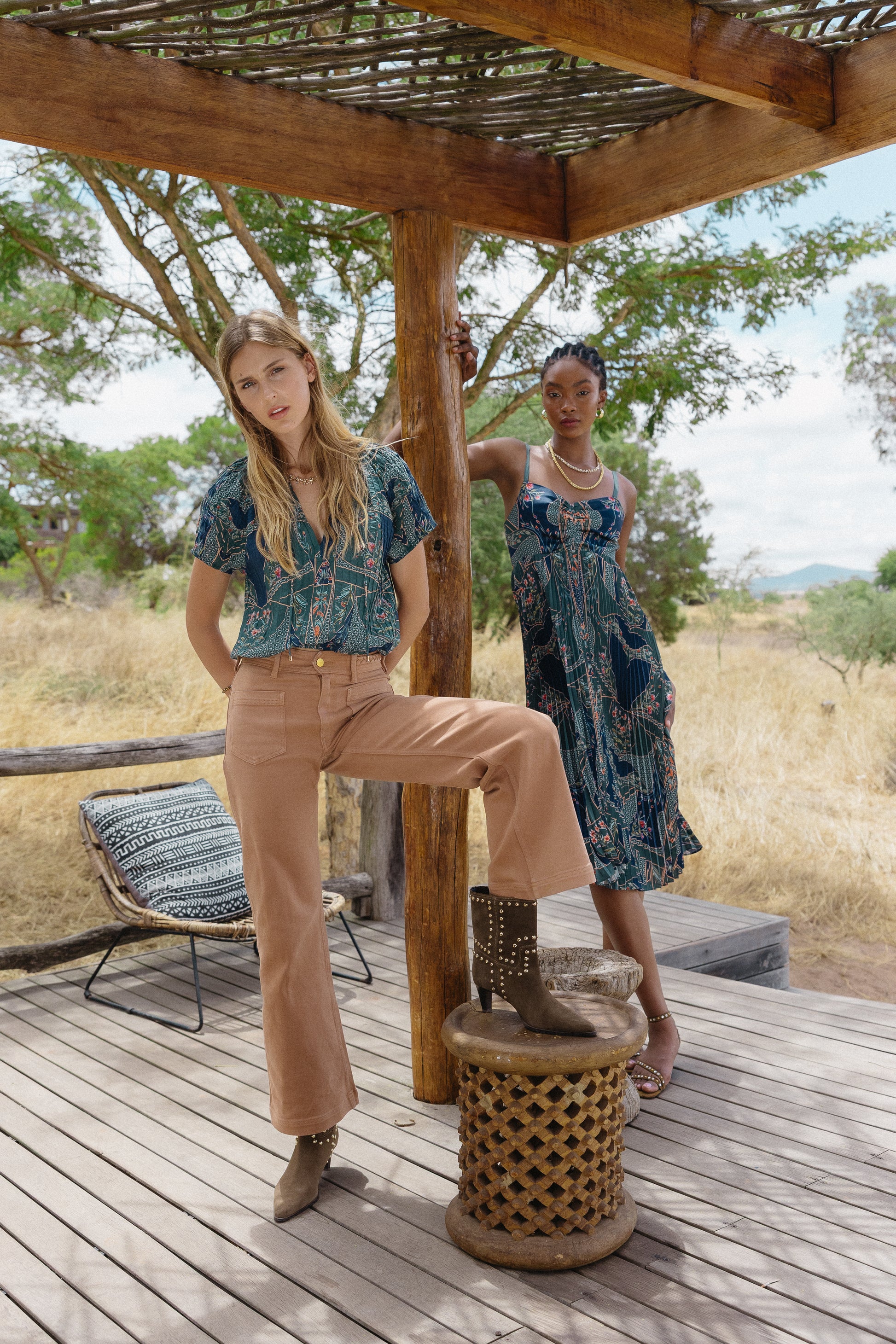 Wide outdoor lifestyle image of the Zola Top in Patchwork Flower styled with brown pants