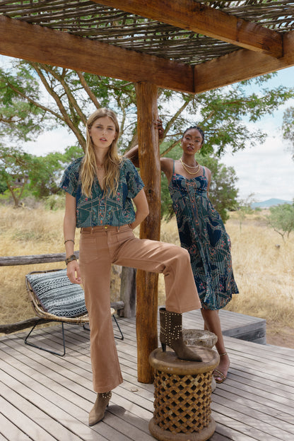 Model wearing the Zola Top in Patchwork Flower in an outdoor editorial setting with coordinated seasonal styling
