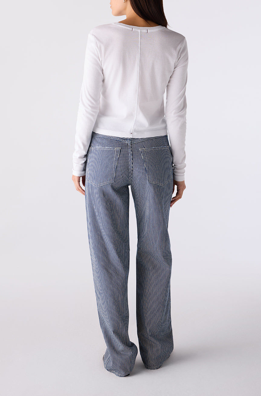 Woman wearing the Little Rowdy Annette Jean in blue and ivory striped denim, back view