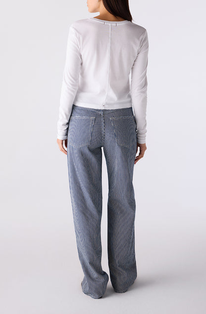 Woman wearing the Little Rowdy Annette Jean in blue and ivory striped denim, back view