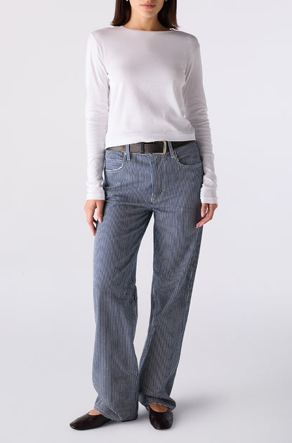 Woman wearing the Little Rowdy Annette Jean in blue and ivory striped denim, front view