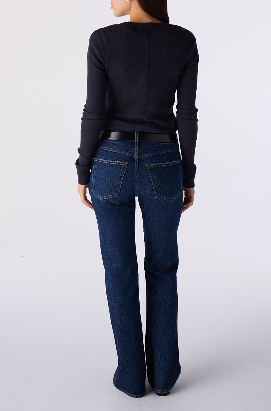 Woman wearing the Little Rowdy Marcenia Jean in dark indigo denim, back view